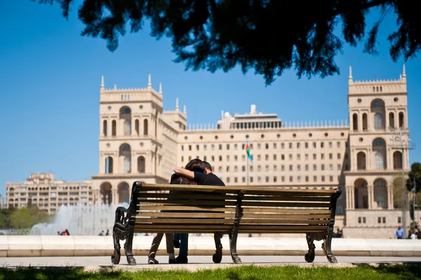 People in love sitting on the bench Stock Image