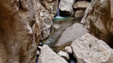 Engebeli bir vadide el değmemiş, sakin bir şelaleyle beslenen sakin bir havuz ile heybetli bir vaha oluşturan el değmemiş ve sakin bir doğal vadi.