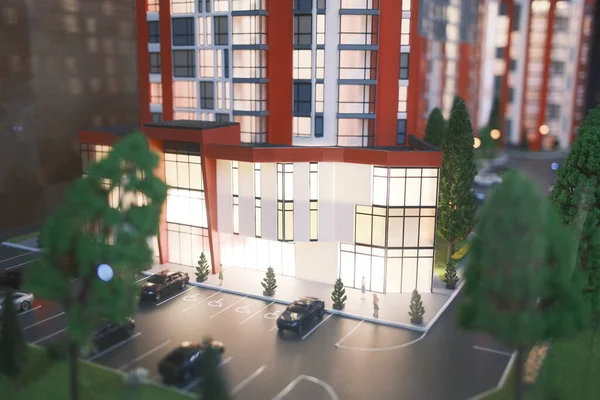 Apartman binasının minyatüründe arabalar ve küçük ağaçlar var..