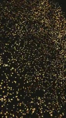 Sayısız altın ışık parçacıkları koyu siyah bir zemin üzerinde parlar ve yüzerler. Bu da güzel bir soyut etki yaratır..