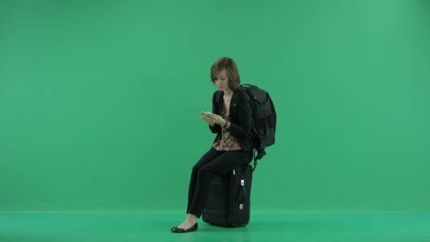 Kvindelig turist venter sidder på kufferten – Stock-video
