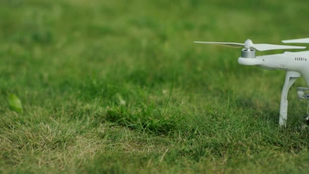 Quadrocopter standing on the grass. green background. summer — Stock Video