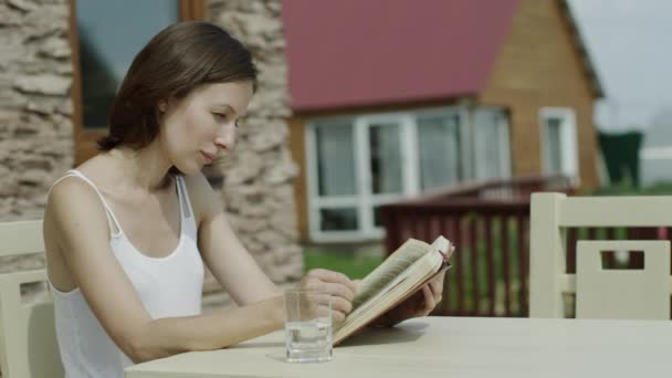 Giovane donna attraente lettura libro dall'albero nel parco, dolly shot — Video Stock