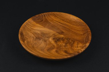 Yuvarlak bir ahşap servis tabağı pürüzsüz bir yüzey ve zengin doğal tahıl sergiliyor. Toplantının veya ev dekorasyonunun geliştirilmesi için mükemmel..