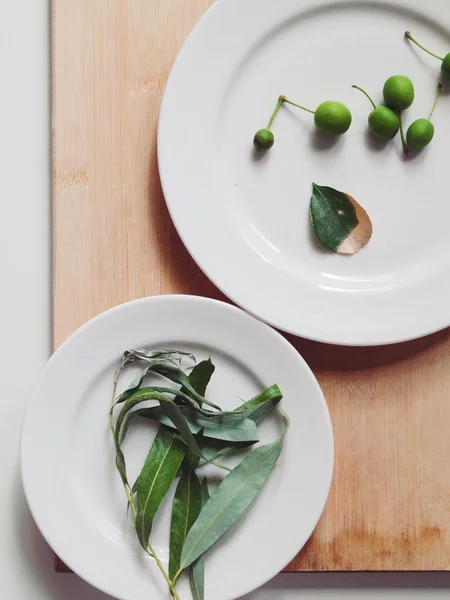 Fresh wild green plum and leaves Stock Image