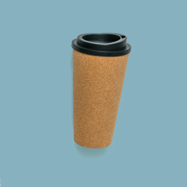 A paper coffee Cup with a black lid on a blue background. — Stock Photo, Image