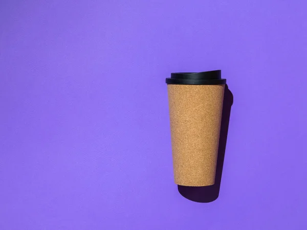 Coffee Cup with a black lid on a purple background. — Stock Photo, Image