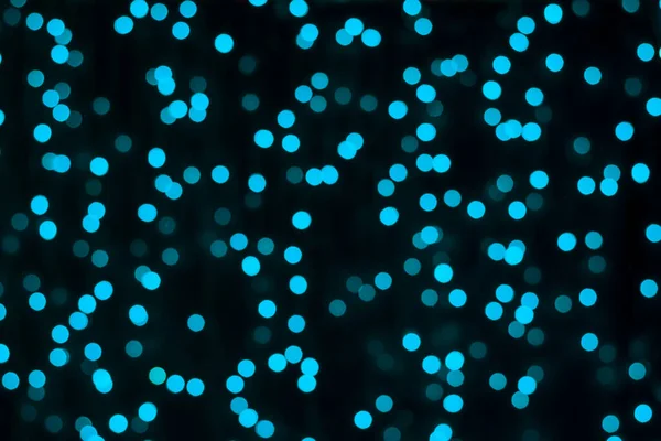 Blurry bokeh background of glowing turquoise lights. — Stock Photo, Image