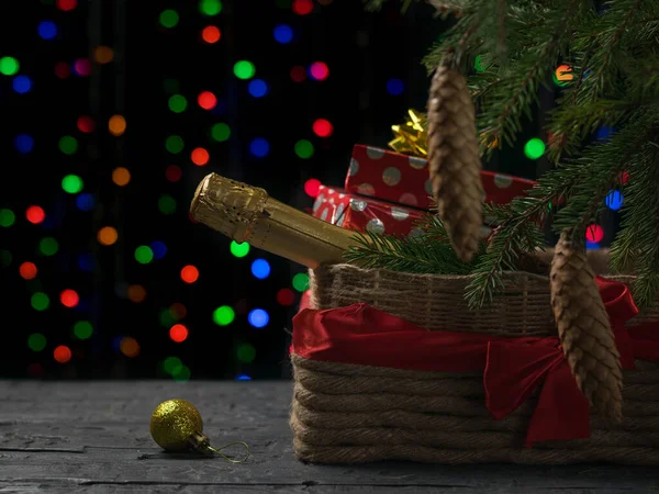 크리스마스 트리 밑에 선물과 와인이 담긴 빈티지 바구니. — 스톡 사진