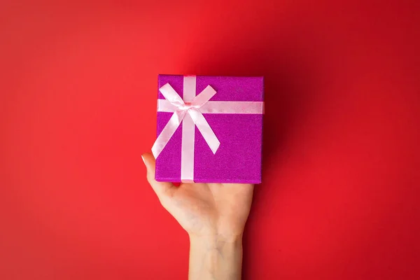 Left Female Hand Gift Box Red Background Surprise Hands Girl — Stock Photo, Image