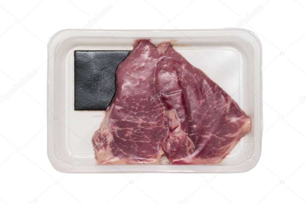 A large fresh piece of meat in a vacuum-sealed package isolated on a white background. Sealed packaging for meat.