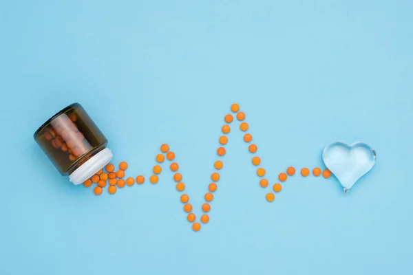 Orange Pills Poured Out Glass Jar Form Cardiogram Concept Treatment — Foto de Stock