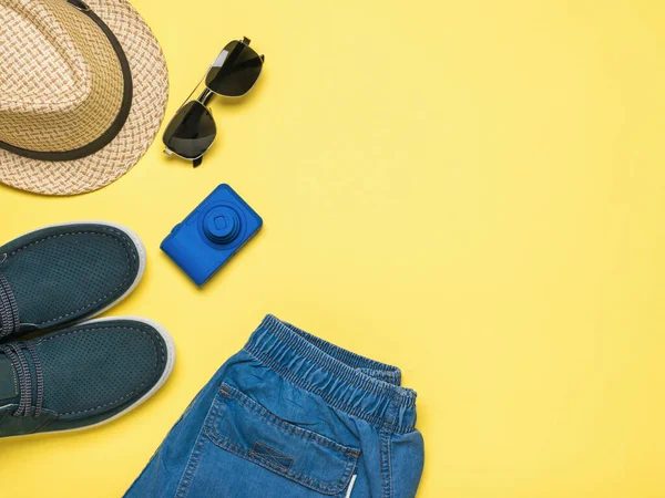 Men\'s accessories for leisure and travel on a yellow background. Space for the text. Flat lay.