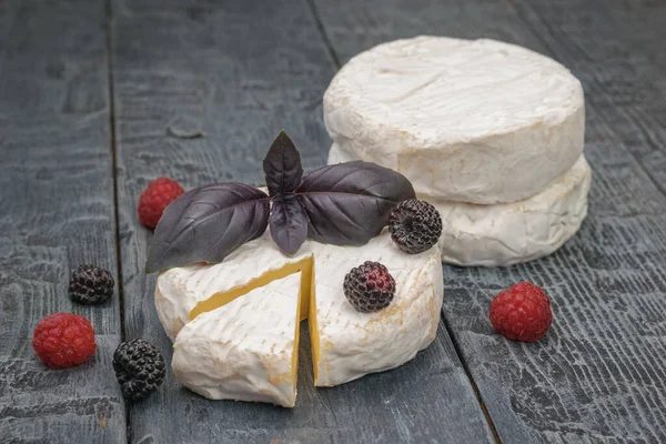 Few Camembert Cheeses Berries Basil Wooden Table Product Made Natural — Fotografia de Stock