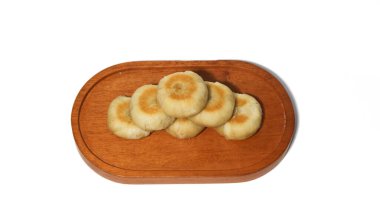 Bakpia is a flat, round cake made from a mixture of chocolate and sugar, wrapped in flour dough, and baked. It's a popular souvenir from Yogyakarta.