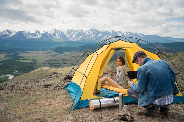 man with the camera filmed the girl on the nature in the mountains