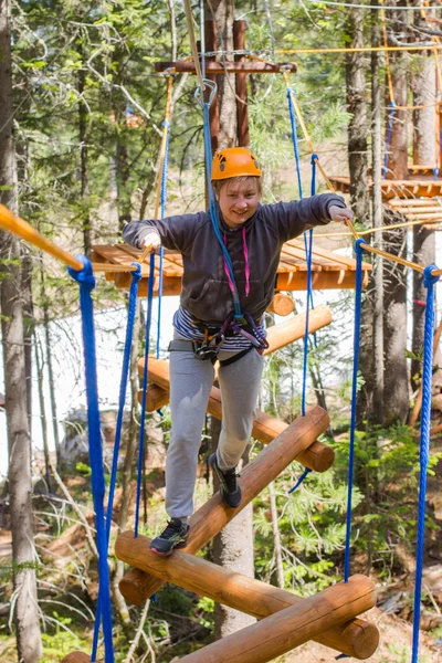 girl climbs into ropes course