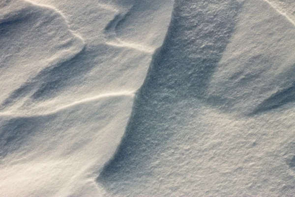 Hintergrund Schneewellen bei Sonnenuntergang durch den Wind — Stockfoto