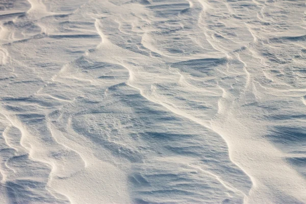 Hintergrund Schneewellen bei Sonnenuntergang durch den Wind — Stockfoto