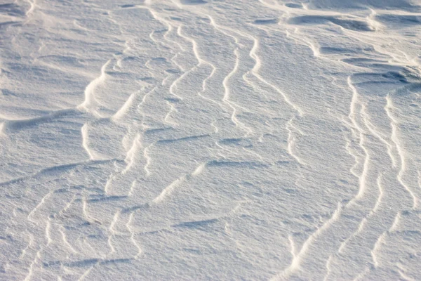 Bakgrunden snö vågor vid solnedgången av vinden — Stockfoto