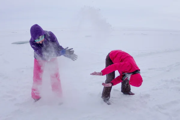 Women play in the snow during a snowfall on the ice of Lake Baik — Stock Photo, Image