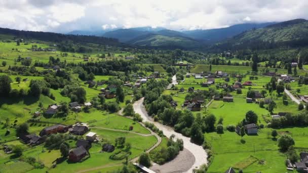 Montañas pueblo paisaje con río y hermosas casas de madera vintage vista aérea. — Vídeos de Stock