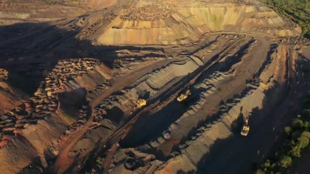 Heavy mining machinery in a quarry aerial evening view. — Stock Video