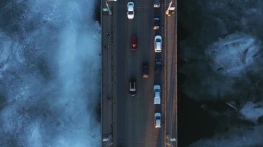 Köprünün üst görüntüsünde şehir trafiği var. Sihirli mavi buz nehri