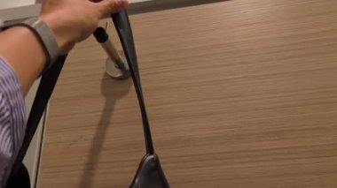 Tuvalet, kişisel hijyen ve güvenlik kavramını kullanmadan önce Omuz Çantasını Kancaya Asan Kadın Tuvalet Kapısı Arkasında