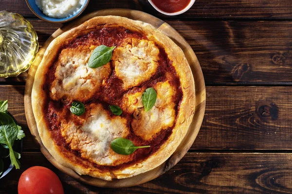 Close up of vegan pizza margherita with cauliflower creamy cheese. Vegan food concept