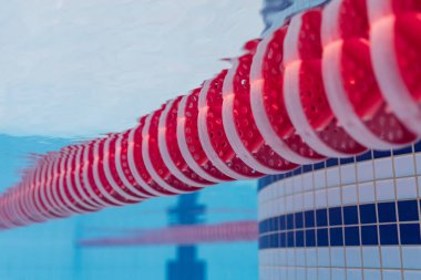 Underwater View of Red and White Racing Lane Line in a Professional Olympic Swimming Pool during Competition or Training.