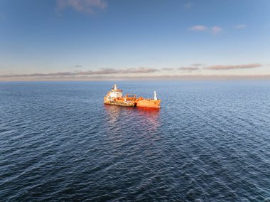 Baltık Denizi 'nde yakıt ikmali yapan turuncu bir petrol tankeri ve bir sığınak gemisinin insansız hava aracı görüntüsü..