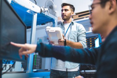 Laboratuvarda Asyalı Mühendisler Bakım Robot Kolu ile buluşacağım. Modern ekipmanlarla Yüksek Teknoloji Araştırma Laboratuvarındalar. Teknoloji ve Yenilik Konsepti. Profesyonel Japon Geliştirme Mühendisi Bir Yapay Zeka Testi Yapıyor.