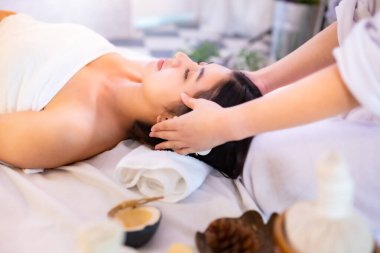 Asyalı güzel, genç ve sağlıklı bir kadın spa salonunda. Masaj tedavi spa odası. Geleneksel tıp ve iyileştirme kavramı.