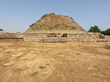 Dharmarajika stupa ancient Buddhist monument in Taxila built by Ashoka surrounded by ruins under daylight sky