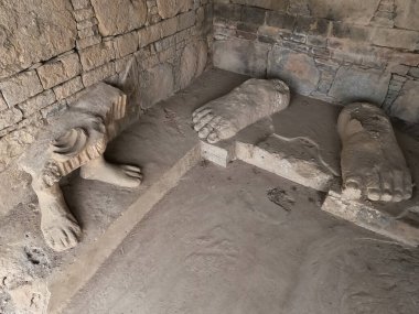 Ancient Buddha feet sculpture remains at Dharmarajika stupa Taxila Pakistan symbolizing peace devotion and Buddhist art
