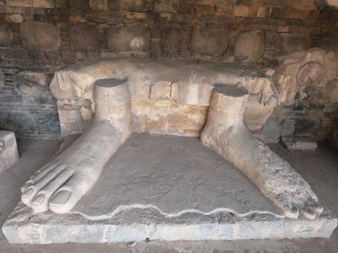 Ancient stone carving of Buddha feet in Dharmarajika Taxila Pakistan symbol of spirituality and historic devotion