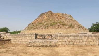 Dharmarajika Stupa view surrounded by ancient stone walls showing Buddhist architecture and Gandhara craftsmanship in Taxila Pakistan