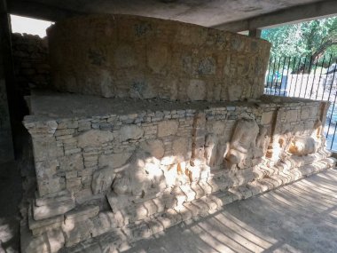 Heritage Buddhist stupa carvings showing mythological figures and sacred motifs Mohra Muradu Taxila Pakistan