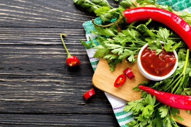 Domates sosu salsa, sıcak biber, maydanoz, fesleğen, ahşap bac üzerinde