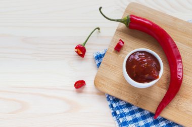 Domates sosu salsa, ahşap arka plan üzerinde sıcak biber.