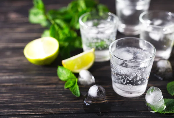 Cocktail with soda water, ice, lime and mint