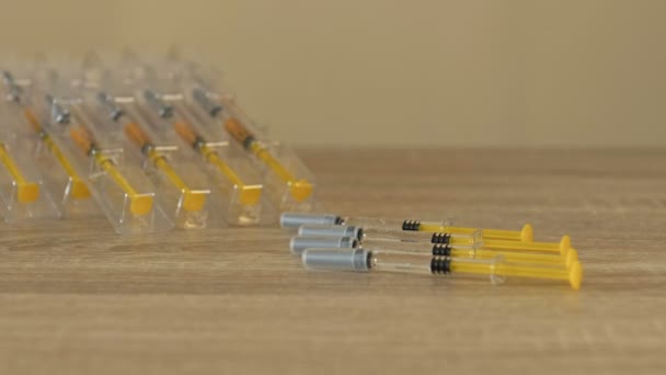 Nurses hands preparing a syringe for injection or vaccination. Wearing protective latex gloves. Close-up. — Stock Video