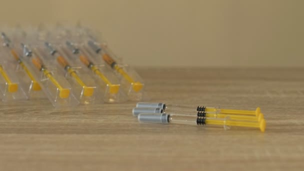 Nurses hand preparing a syringes for injection or vaccination. Wearing protective latex gloves. Close-up. — Stock Video