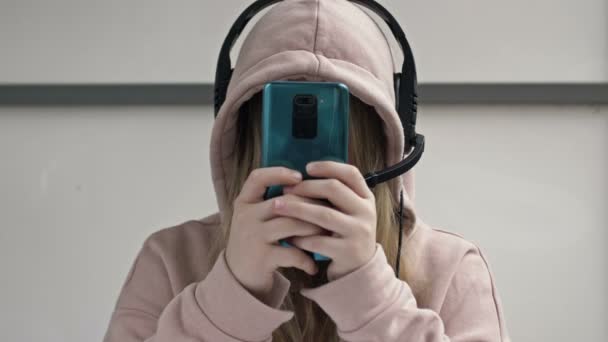 Teenager blickt auf den Smartphone-Bildschirm, ohne aufzublicken. Moderne Sucht. — Stockvideo