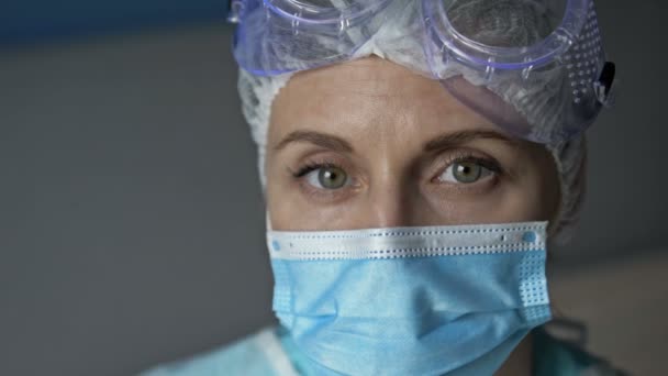 Portret zmęczonej lekarki lub pielęgniarki zdejmującej maskę ochronną. Zbliżenie. — Wideo stockowe
