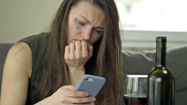 울고 있는 여자가 누군가에게 전화를 하려고 합니다. 혼자 와인을 마시고 있다. 고통, 고통, 정신적 고통. — 비디오