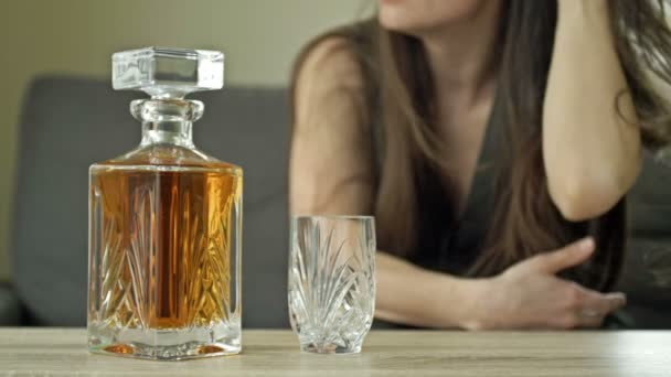 Een huilende vrouw drinkt alleen whisky. Close-up van een prachtige decanter en een kristalglas. Vrouwelijk alcoholisme tegen de achtergrond van volledig welzijn en welvaart. Sociaal probleem. — Stockvideo