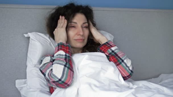 Портрет больной женщины, страдающей от головной боли. Мигрень, похмелье или высокая температура. Крупный план. — стоковое видео