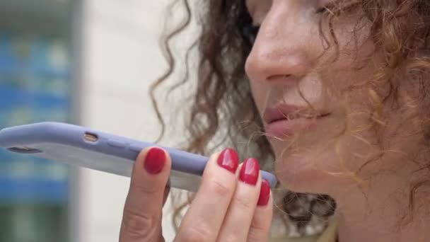 Retrato de una hermosa mujer de mediana edad hablando en un teléfono celular en la calle. — Vídeos de Stock